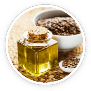 Organic flaxseeds and flaxseed oil in a spoon, illustrating the omega-3 rich content for nail and skin nourishment.