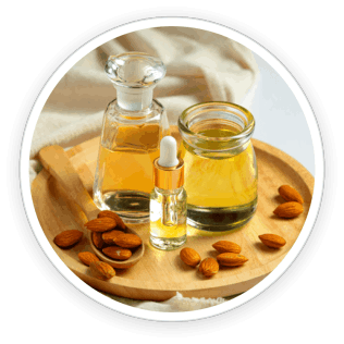Sweet almonds and a bottle of almond oil, symbolizing deep hydration and vitamin enrichment for skin and nails.